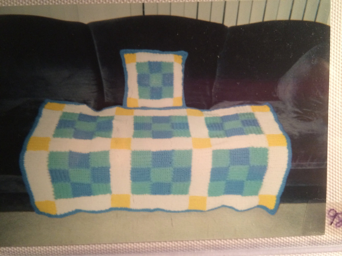Soft pastel multicolor crocheted baby afghan with white scallop border